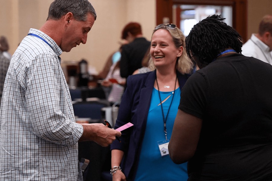 Attendees networking and laughing